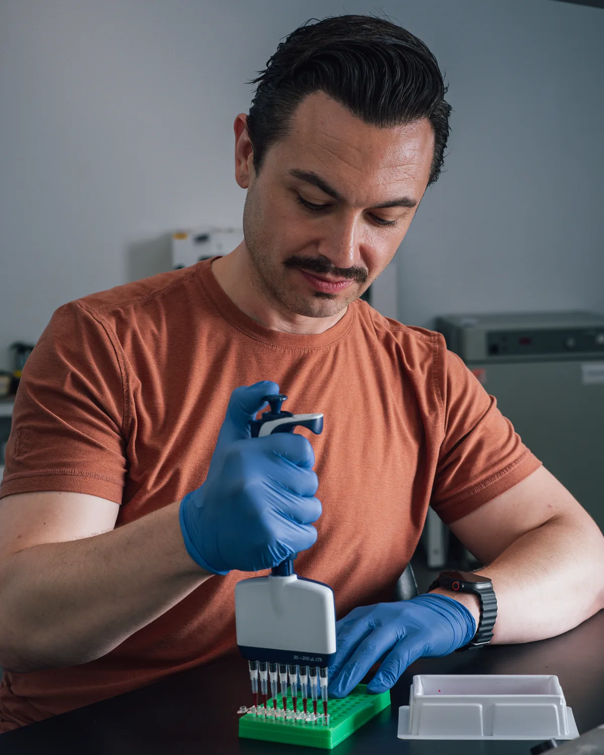 A scientist loading samples with a multichannel pipette.